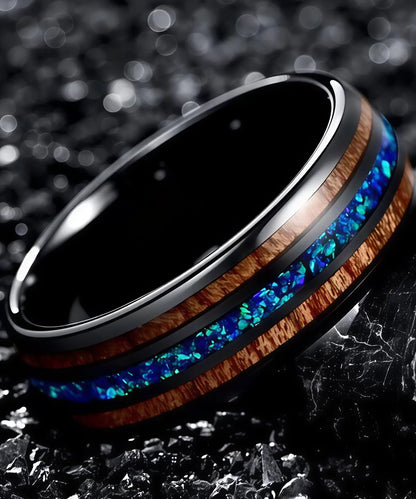 Gros plan sur la bague en bois Ark Benetto en tungstène noir, incrustée de bois de koa et opale bleue scintillante