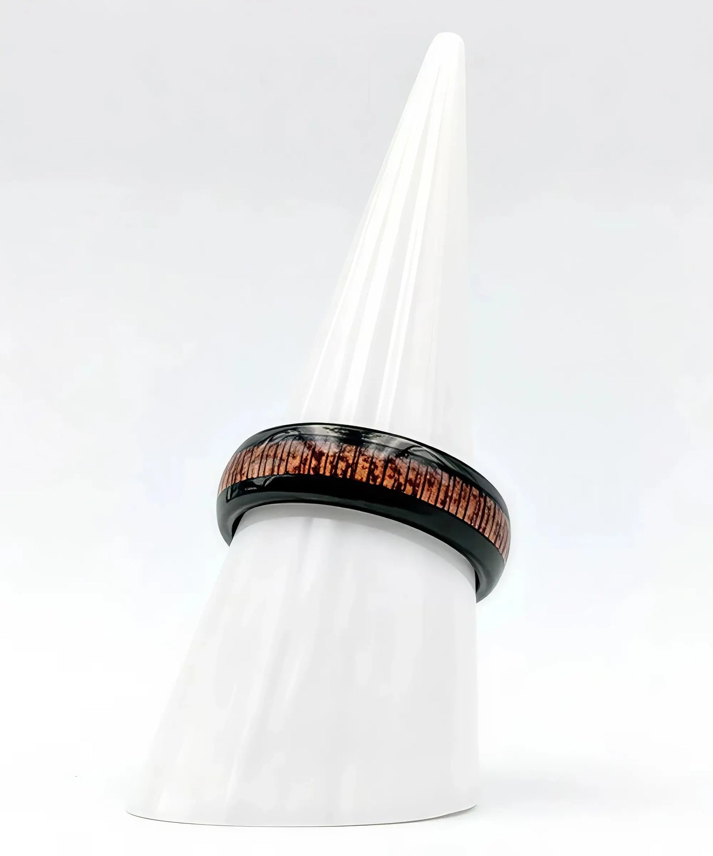Bague en bois Elior Klimt noire avec incrustation bois marron, présentée sur un cône blanc minimaliste